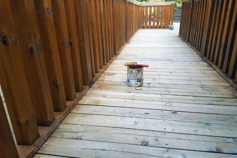 a can and and brush on top in a deck hallway